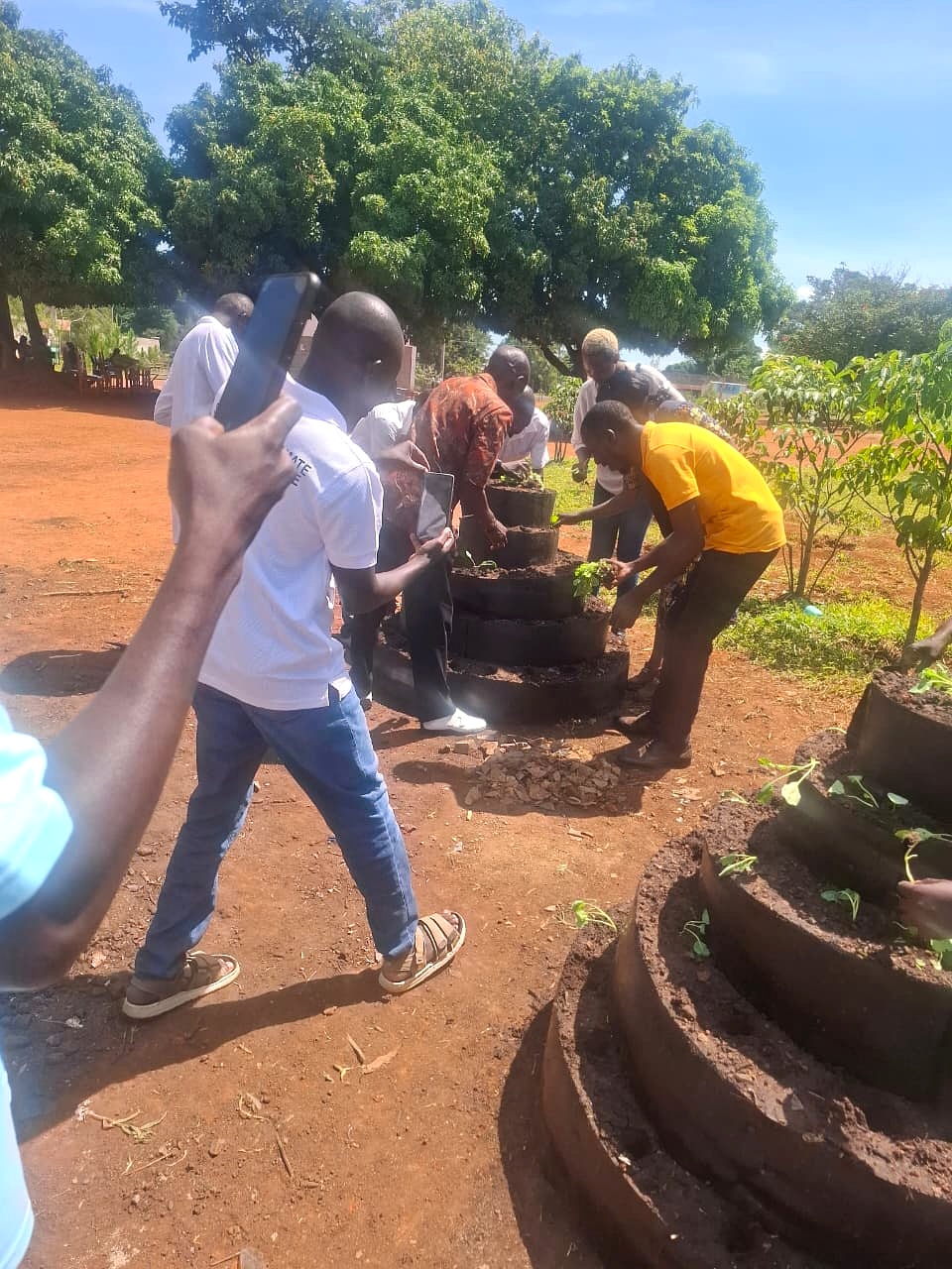 A SUCSA trainer guiding a tower-garden planting activity