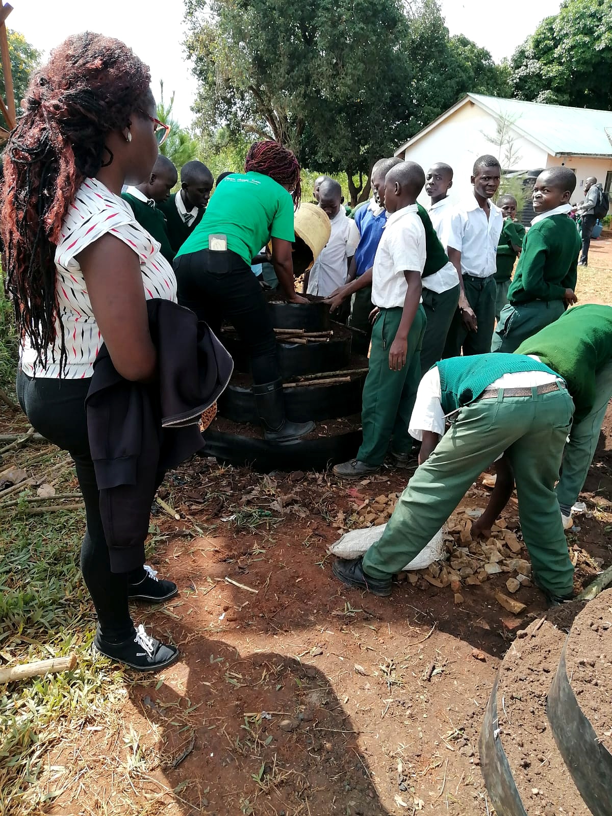 Pupils and teachers taking part in a SUCSA tower-garden planting session